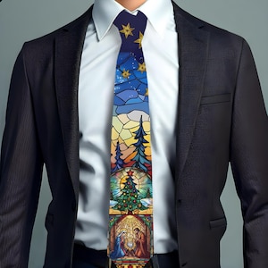 May include: A colorful Christmas-themed tie featuring a stained-glass design. The tie displays a night sky with stars, a Christmas tree, and a Nativity scene. The tie is worn with a white dress shirt and a black suit jacket.