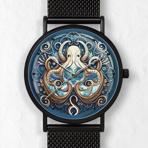 May include: Black wristwatch with a round face featuring an octopus design. The watch face has a blue background with a detailed illustration of an octopus in cream and gold tones. The watch has a black mesh band.