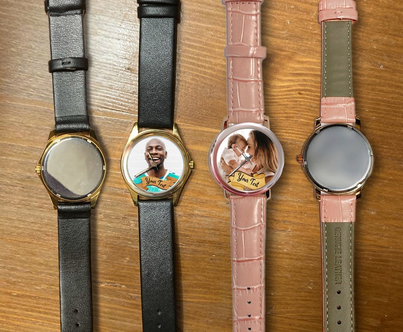 May include: Four wristwatches with different colored bands and face designs. The watches have gold-colored cases and are displayed on a wooden surface. One watch has a photo of a person on the face, another has a photo of a mother and child, and the other two have blank faces.