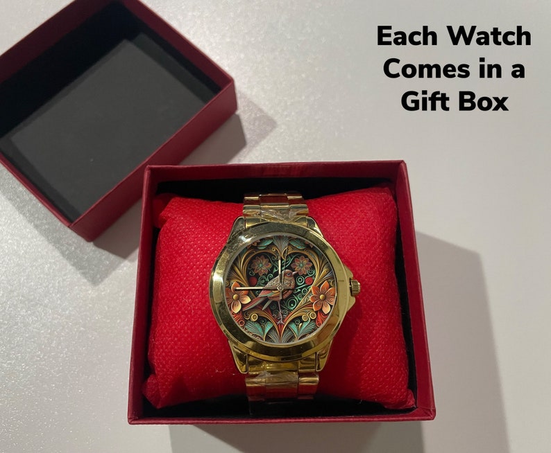 May include: A gold watch with a colorful floral design on the face is displayed in a red gift box. The text "Each Watch Comes in a Gift Box" is visible above the box.
