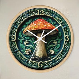 May include: A round wall clock with a wooden frame and a green and blue face. The clock features a large, red and orange mushroom with white spots and a white stem. The numbers 12, 9, 6, and 3 are visible on the clock face.