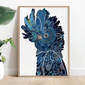 May include: A framed art print featuring a stylized blue parrot with intricate feather details. The artwork showcases a vibrant color palette of blues, teal, and gold, with a detailed eye and a neutral-toned beak. The print is set against a white background.