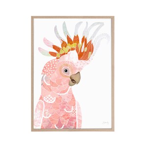 May include: A framed art print featuring a detailed illustration of a pink cockatoo. The bird has a patterned design with shades of pink, orange, and white. The artwork is set against a white background and framed in a light-colored wood frame.
