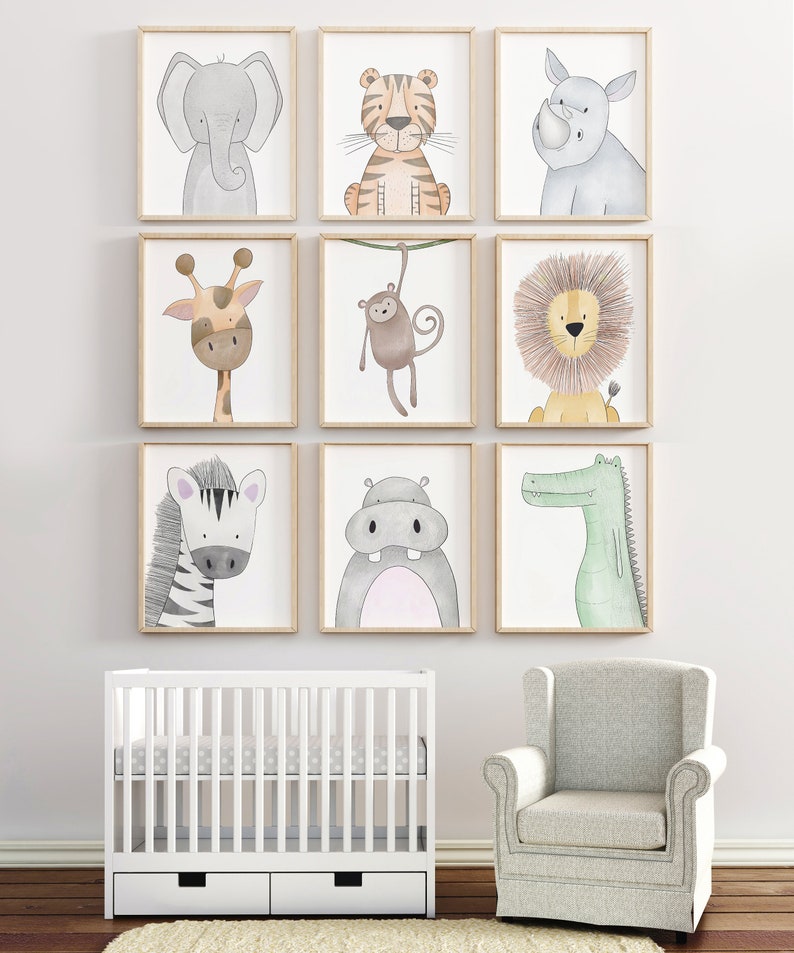 Puede incluir: Nueve impresiones enmarcadas de animales en acuarela, incluyendo un elefante, tigre, rinoceronte, jirafa, mono, le&oacute;n, cebra, hipop&oacute;tamo y cocodrilo. Se exhiben sobre una cuna blanca y un sill&oacute;n gris.
