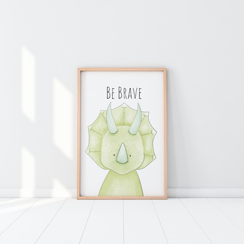 May include: A framed print with a green cartoon triceratops and the text "BE BRAVE" in black.