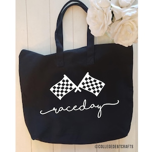 May include: Black canvas tote bag with white checkered flags and the text "raceday" in a cursive font.