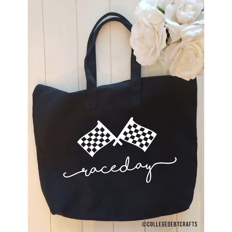 May include: Black canvas tote bag with white checkered flags and the text "raceday" in a cursive font.