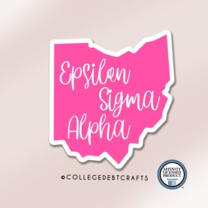 May include: Pink vinyl sticker of the state of Ohio with the text "Epsilon Sigma Alpha" in white cursive lettering.