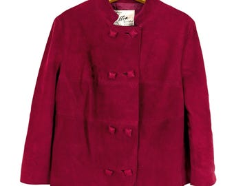 May include: A deep red suede jacket with a mandarin collar and decorative square buttons. The jacket is double-breasted and has a label that reads "Ellen Boutique". The jacket is hanging on a wooden hanger.