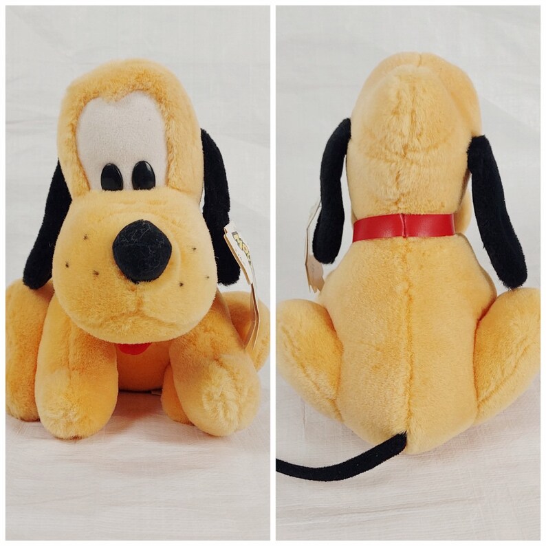 May include: A plush brown and black dog toy with a red collar. The toy is sitting on a white surface.