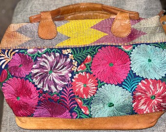 Handmade vintage floral embroidered handbag featuring two light brown leather handles and one long crossbody strap