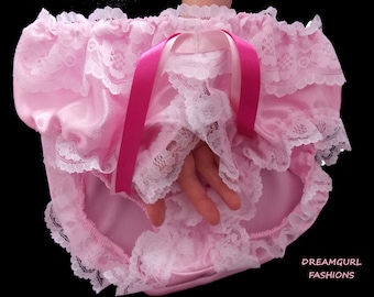 May include: Pink satin and lace underwear with a pink ribbon bow. The underwear has a ruffled edge and is made of soft, delicate fabric.
