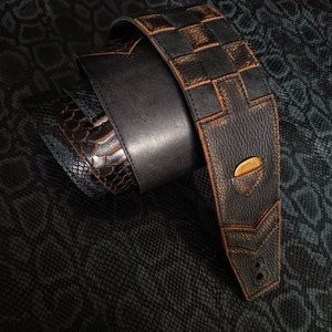 Black and brown leather guitar strap with pick holder