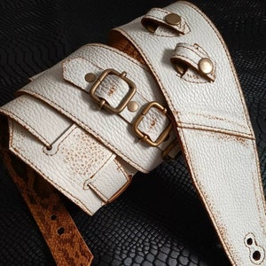 White leather guitar strap with buckles