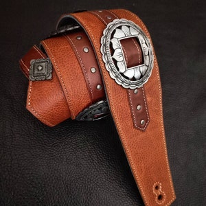 Brown leather guitar strap with conchos