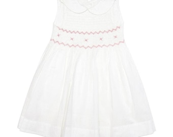May include: A white sleeveless dress with a pink embroidered neckline and a smocked bodice.