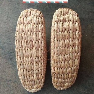 May include: Two straw sole inserts, likely for footwear, are displayed against a dark background. The woven texture of the straw is visible. Text at the top reads "straw sole" and at the bottom "Homeuse only".