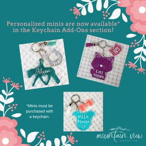 May include: Three personalized keychain charms with glitter and a tassel. The charms are a teal horse with the name Alyssa, a purple cat with the text "Cat Mom" and a turquoise onesie with the text "Pittie Mama".