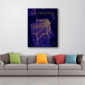 May include: A dark blue canvas print with a map of San Francisco, California. The map is outlined in yellow and shows the city's streets and landmarks. The text "SAN FRANCISCO" is printed in gold at the top of the print.