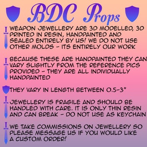 May include: A gradient pink and purple background with the text "BDC Props". The text describes weapon jewelry that is 3D modeled, 3D printed in resin, hand-painted, and sealed. The jewelry varies in length between 0.5-3 inches.