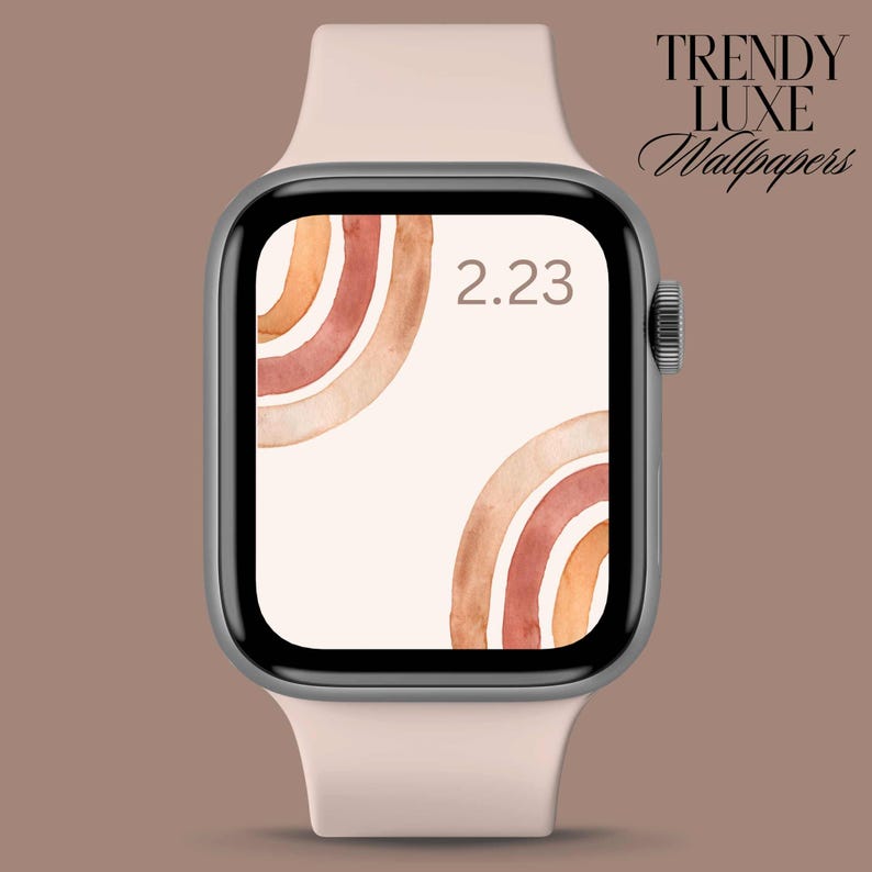 May include: A pink Apple Watch with a white watch band displays a digital clock face with the time 2:23. The watch face has a background of abstract watercolor arches in shades of orange, brown, and red.