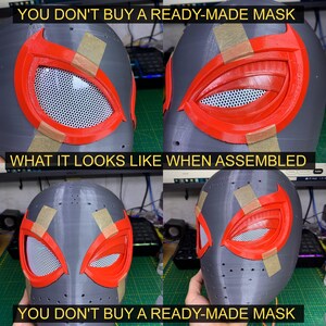 K&ouml;nnte beinhalten: Nahaufnahme einer grauen, im 3D-Druck hergestellten Maske mit roten und schwarzen Details. Die Maske ist teilweise zusammengebaut, die Augen- und Mundpartien sind noch mit Klebeband befestigt. Der Text "YOU DON'T BUY A READY-MADE MASK" ist &uuml;ber und unter dem Bild zu sehen.