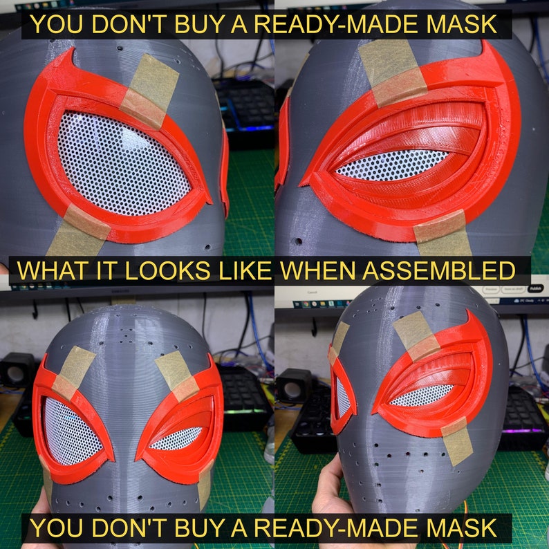 K&ouml;nnte beinhalten: Nahaufnahme einer grauen, im 3D-Druck hergestellten Maske mit roten und schwarzen Details. Die Maske ist teilweise zusammengebaut, die Augen- und Mundpartien sind noch mit Klebeband befestigt. Der Text "YOU DON'T BUY A READY-MADE MASK" ist &uuml;ber und unter dem Bild zu sehen.