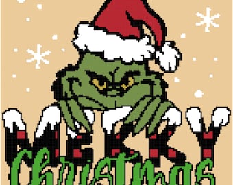 May include: A green Grinch wearing a red Santa hat with white trim and a white fur collar. The Grinch is standing on the word "Merry" and the word "Christmas" is written in green below. The background is a light brown color with white snowflakes.
