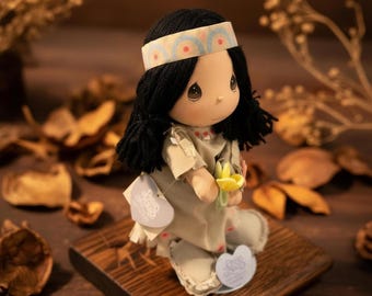 Gorgeous collectible and vintage Precious Moments Native American Doll With Display Stand.