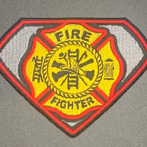 May include: A red, black, and yellow embroidered patch with a firefighter's helmet, axe, and ladder inside a circle. The words "FIRE FIGHTER" are written on the patch.