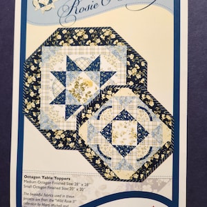 May include: A sewing pattern titled Rosie O' Doiley by Sonja Lea Designs featuring two octagon table toppers. The patterns show blue and cream floral and plaid fabrics. Text includes: Medium Octagon Finished Size: 28" x 28", Small Octagon Finished Size: 20" x 20".