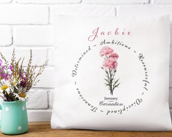 May include: White pillow with a pink carnation flower and the text "Jackie - Ambitious - Resourceful - Determined -  Tender -  Strong - January Carnation"
