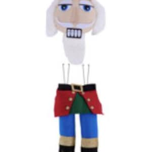 May include: A plush Christmas nutcracker decoration. The top features a red hat with gold trim and a face with a white mustache. The bottom half has blue pants, a red jacket, and black boots with gold accents. A festive holiday decoration.