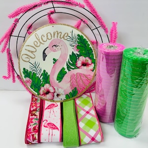 May include: Pink flamingo welcome sign with green tropical leaves and pink flowers.  Pink and green mesh ribbon, pink and white flamingo ribbon, and green and white plaid ribbon.  Pink and green wreath supplies.