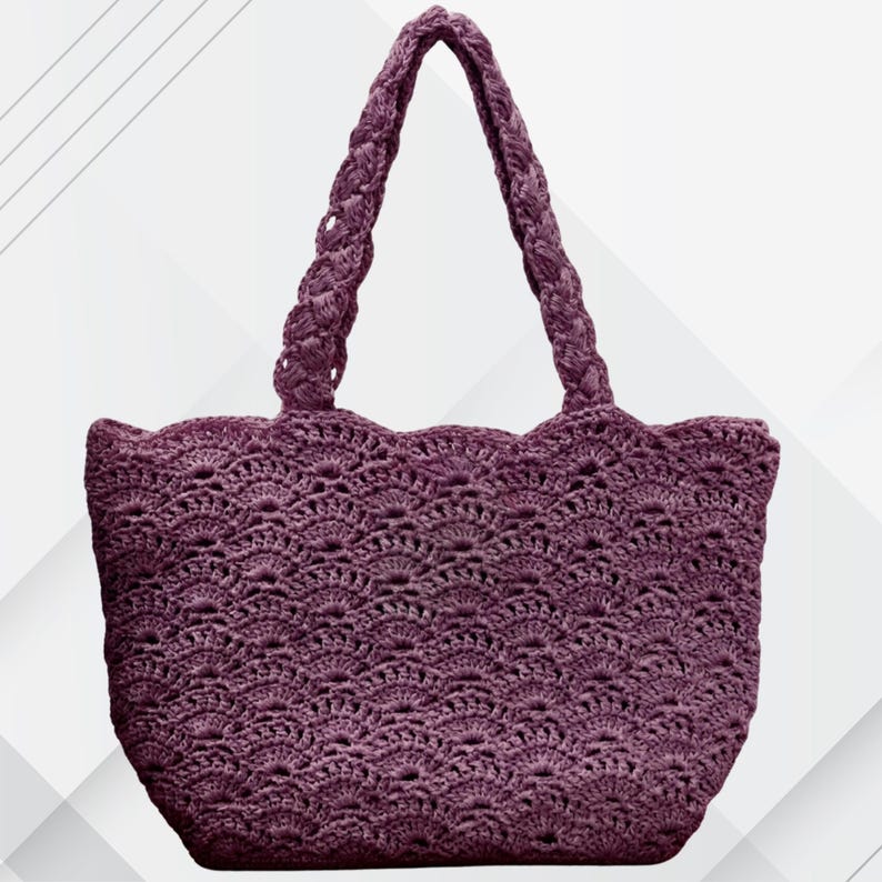 May include: A crocheted tote bag in a deep purple hue. The bag features a scalloped top edge and braided handles. The body of the bag has a detailed openwork pattern, creating a textured appearance. This handmade bag is suitable for carrying various items.