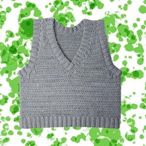 May include: A gray, sleeveless, V-neck sweater vest. The vest is made of a knitted material with a ribbed hem and neckline. The background is white with green paint splatters.