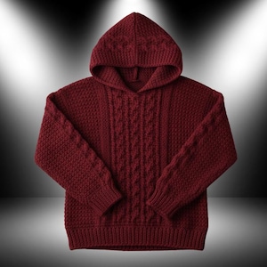 May include: A burgundy-colored, knitted hoodie with a textured pattern. The hoodie features a drawstring neckline, long sleeves, and a ribbed hem and cuffs. The front of the sweater has a cable knit design.