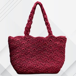 May include: A burgundy crochet tote bag with a scalloped top edge and braided handles. The bag features a detailed openwork pattern throughout the body. The handles are thick and sturdy, designed for comfortable carrying. The bag is a stylish accessory.