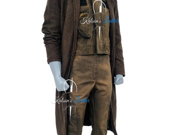 May include: A brown three-piece outfit on a mannequin. The outfit includes a long coat, a vest, and pants. The coat is a darker shade of brown, while the vest and pants are a lighter shade. The outfit has a rugged, worn appearance.