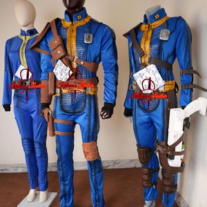 May include: Blue and yellow jumpsuit costumes with brown leather accessories, displayed on mannequins. The costumes feature a zip-up front, padded details, and the number 33 on the collar. Accessories include belts, holsters, and pouches. The costumes are displayed on mannequins.