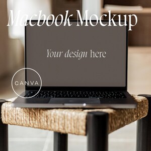 May include: A silver laptop computer with a black keyboard and trackpad is sitting on a woven stool. The laptop screen is blank and says "Your design here" in white text. The laptop has a white sticker on the bottom left corner that says "CANVA".