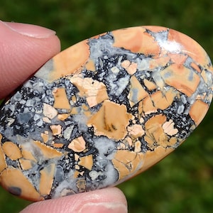 Maligano Jasper Cabochon, Creamy Yellowish White & Blueish Gray, From a Veteran Owned Studio held in hand for scale.