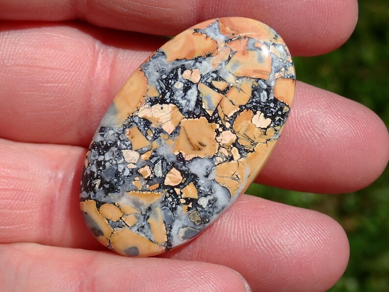 Maligano Jasper Cabochon, Creamy Yellowish White & Blueish Gray, From a Veteran Owned Studio held in hand for scale.