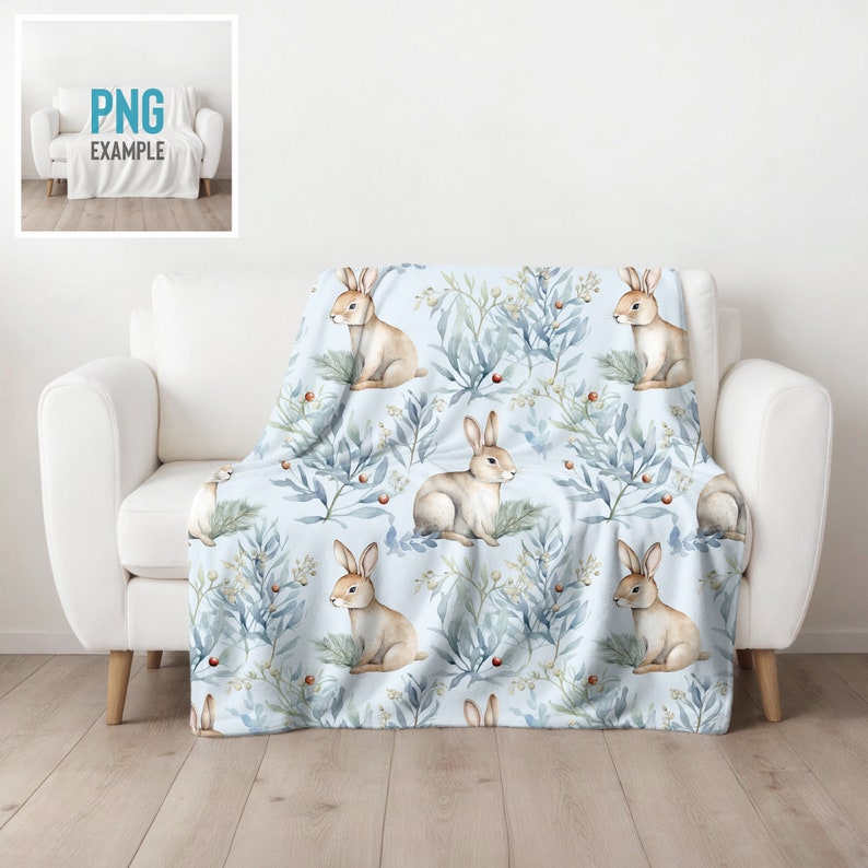 May include: A soft blue throw blanket with a repeating pattern of watercolor bunnies and leafy branches. The bunnies are brown and white and the branches are blue and green.