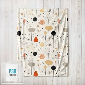 May include: A white throw blanket with a repeating pattern of black, orange, and brown stylized flowers and dots.