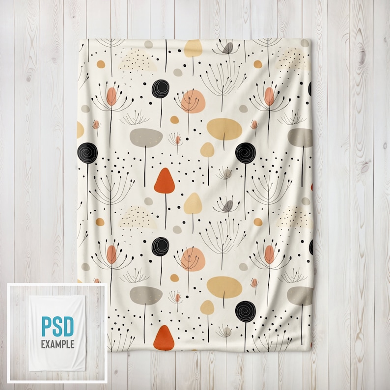 May include: A white throw blanket with a repeating pattern of black, orange, and brown stylized flowers and dots.