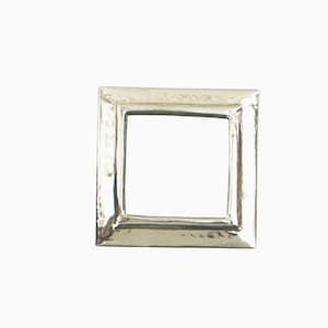 May include: A silver picture frame with a hammered finish. The frame is square and has a simple design.