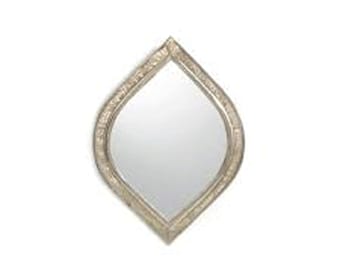 May include: A silver teardrop-shaped mirror with a decorative frame.
