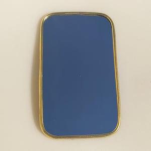 May include: A gold-framed rectangular mirror with a blue reflective surface.