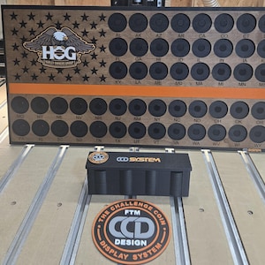 May include: A rectangular wooden display board featuring a dark stained finish, a Harley Owners Group logo, and an American flag pattern with black stars. It includes rows of circular cutouts labeled with state abbreviations and a horizontal orange stripe.